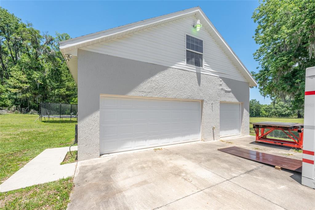 4735 Southeast 112th Street Road Belleview, FL 34420 - Photo 55 of 73 a front view of a house with garden