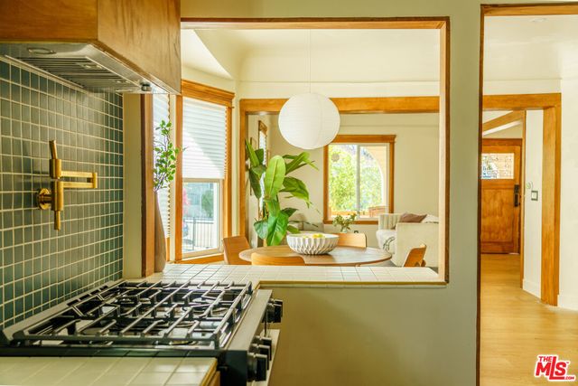 a bathroom with a granite countertop sink and a large mirror
