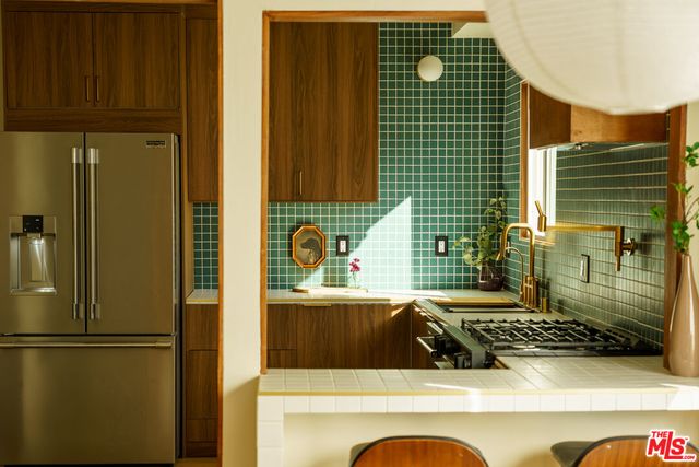 a bathroom with a sink a mirror and shower