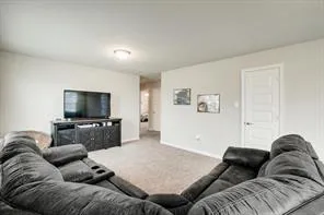 a bedroom with a bed a dresser and window