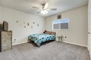 a bedroom with a bed and flat screen tv