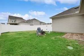a front view of a house with large trees