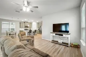 a living room with furniture and wooden floor