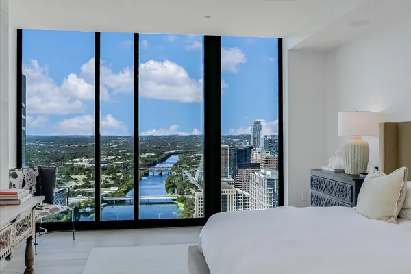 a bedroom with a large window and a bed