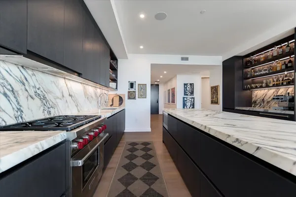 a kitchen with stainless steel appliances granite countertop a stove and a sink