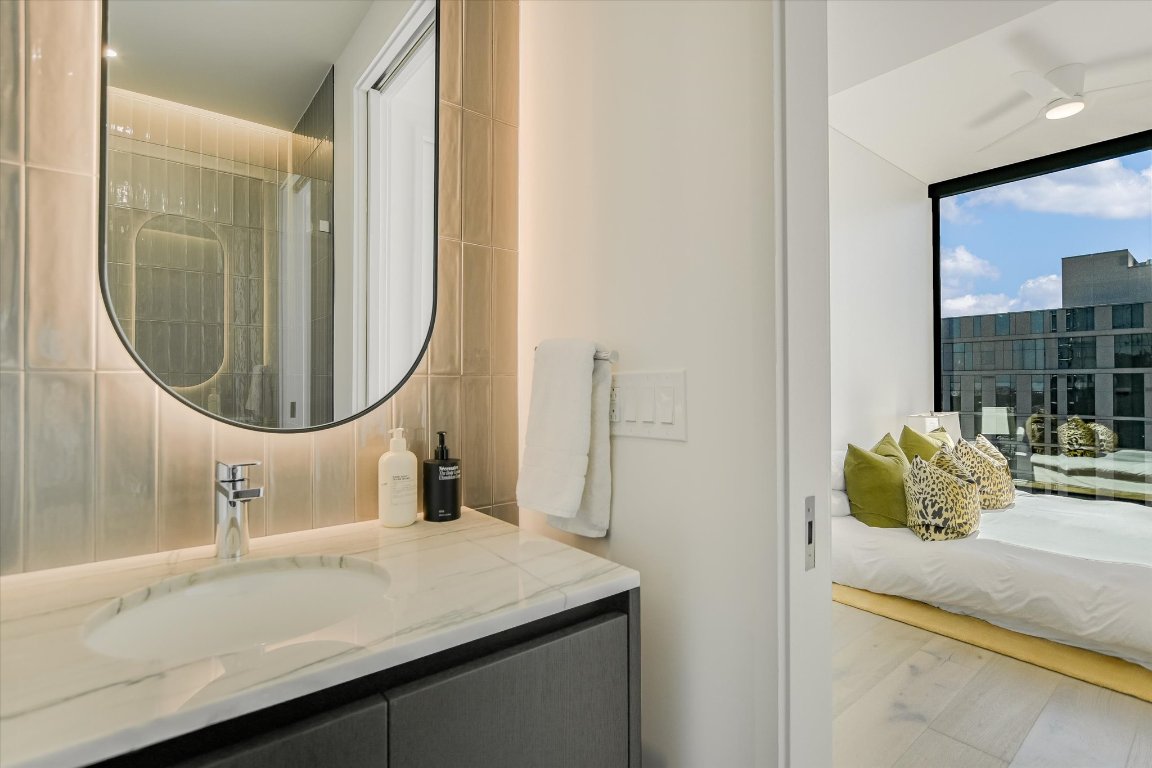 610 Davis Street, Unit 4603 Austin, TX 78701 - Photo 25 of 38 a bathroom with a sink and a mirror