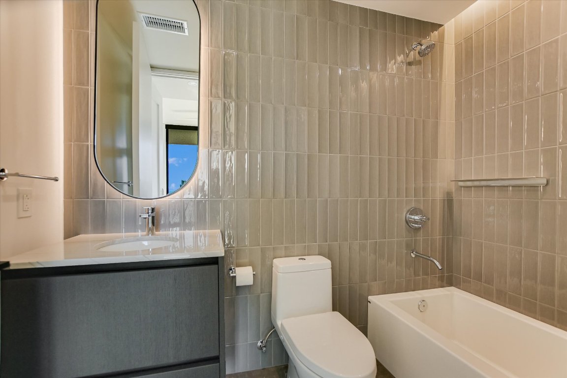 610 Davis Street, Unit 4603 Austin, TX 78701 - Photo 28 of 38 a bathroom with a sink toilet and shower