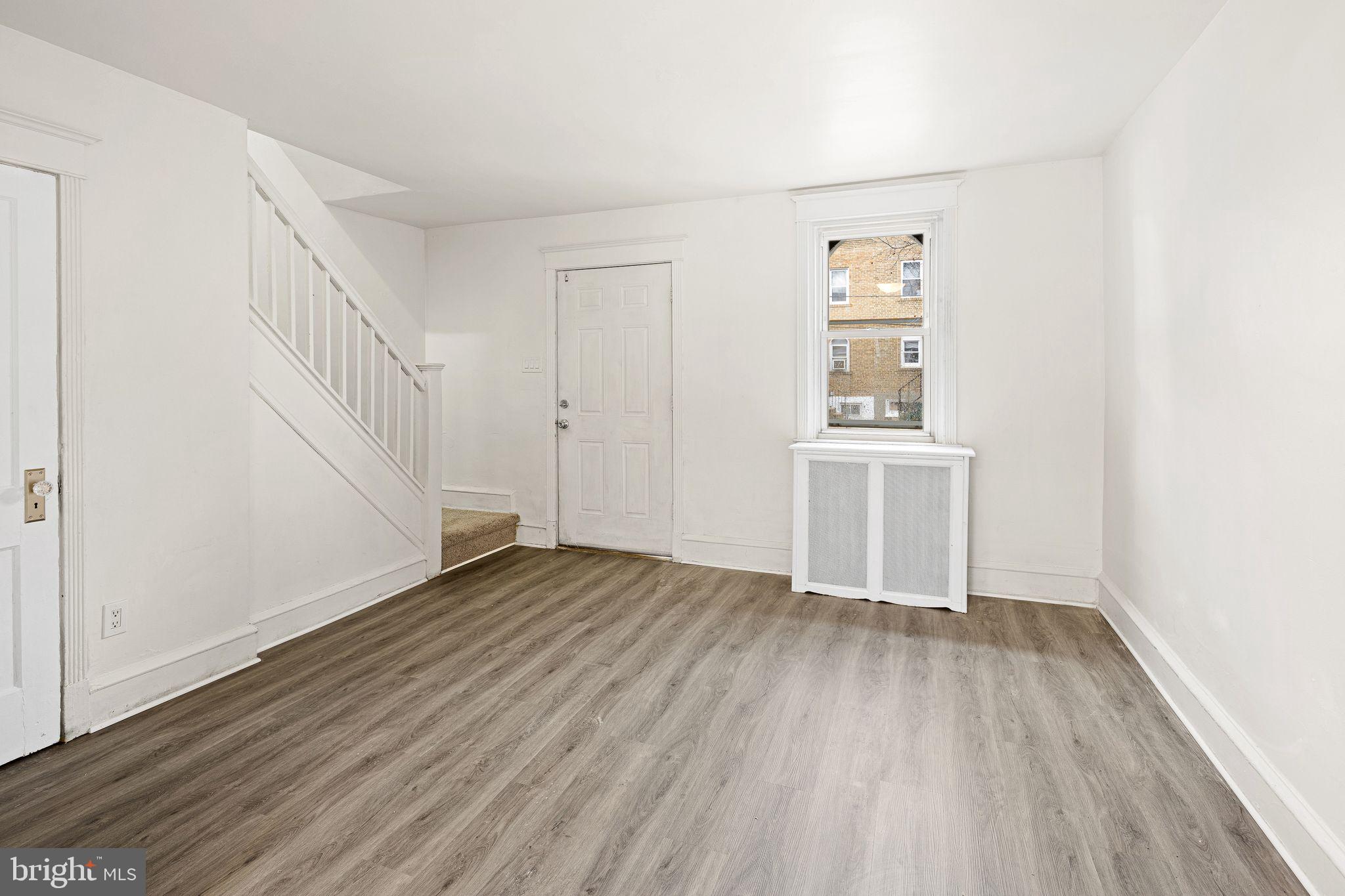 614 Littlecroft Road Upper Darby, PA 19082 - Photo 4 of 13 a view of an empty room with wooden floor and a window