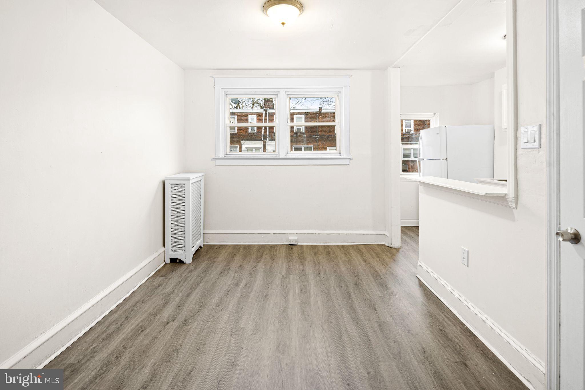614 Littlecroft Road Upper Darby, PA 19082 - Photo 5 of 13 an empty room with wooden floor and windows