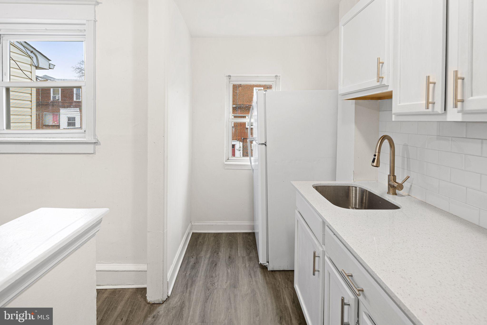 614 Littlecroft Road Upper Darby, PA 19082 - Photo 8 of 13 a kitchen with a sink and a stove with wooden floor