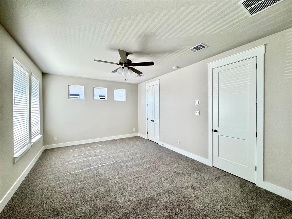 809 Meadowcrest Drive Plano, TX 75075 - Photo 16 of 30 an empty room with windows and fan