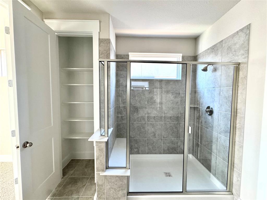 809 Meadowcrest Drive Plano, TX 75075 - Photo 19 of 30 a bathroom with a glass shower door