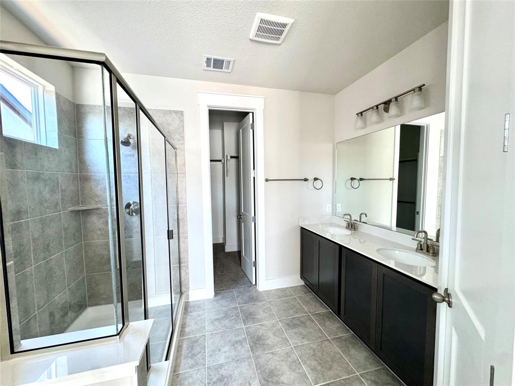 809 Meadowcrest Drive Plano, TX 75075 - Photo 21 of 30 a bathroom with a double vanity sink mirror and shower