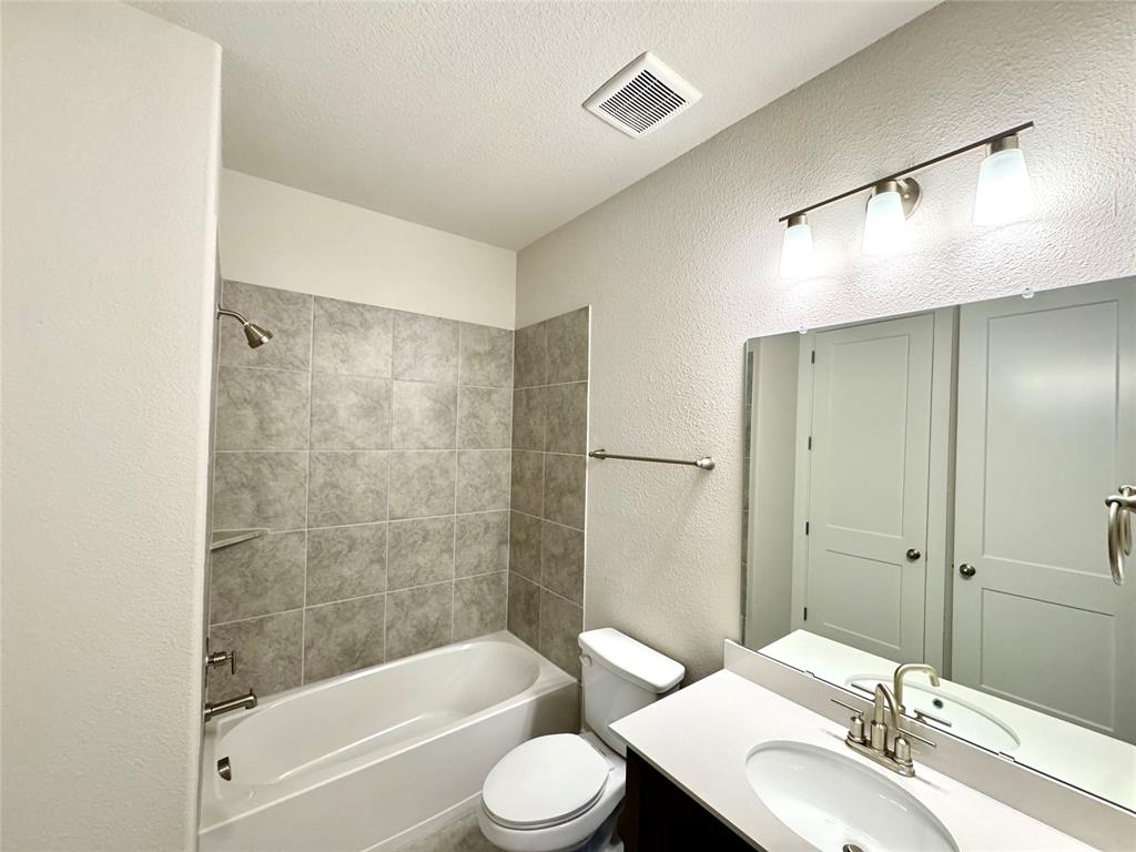 809 Meadowcrest Drive Plano, TX 75075 - Photo 29 of 30 a bathroom with a bathtub shower sink vanity and toilet