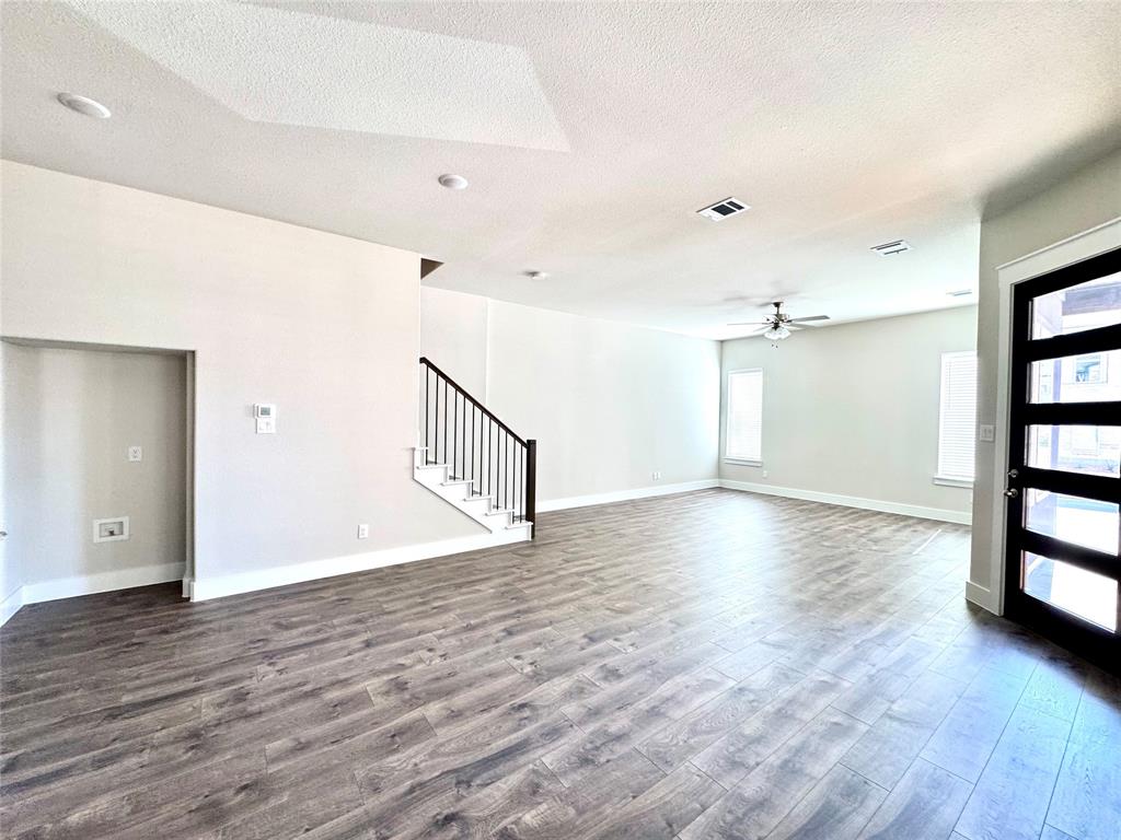 809 Meadowcrest Drive Plano, TX 75075 - Photo 5 of 30 wooden floor in an empty room with a window