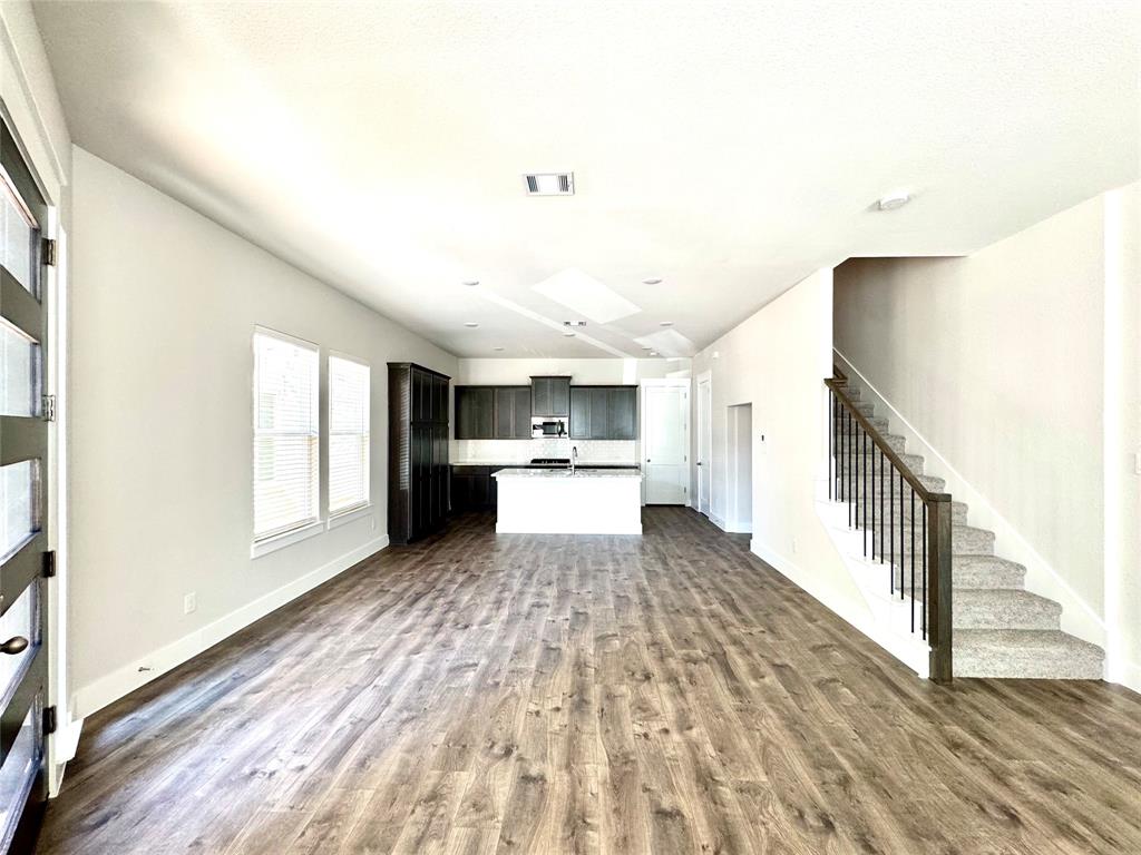 809 Meadowcrest Drive Plano, TX 75075 - Photo 7 of 30 a view of a kitchen with wooden floor and electronic appliances