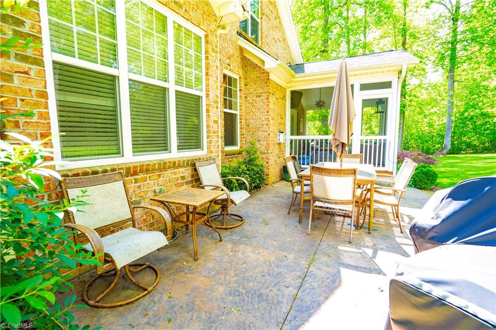 8442 Alice Player Drive Oak Ridge, NC 27310 - Photo 29 of 30 Back showing screened porch and patio