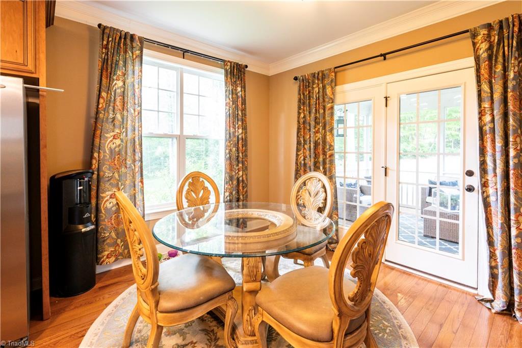 8442 Alice Player Drive Oak Ridge, NC 27310 - Photo 6 of 30 Breakfast area with doors leading to screened porch and patio