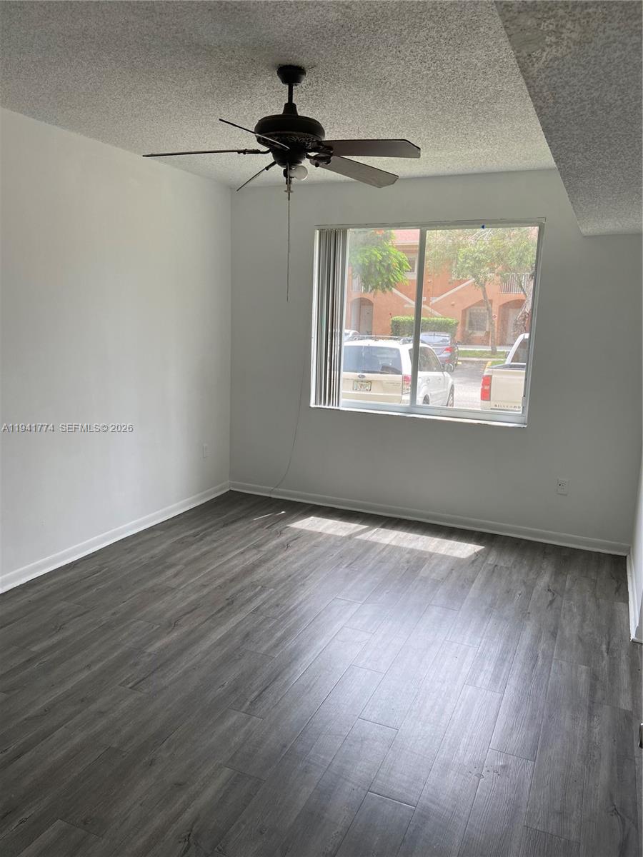 6960 Southwest 39th Street, Unit E107 Davie, FL 33314 - Photo 1 of 2 wooden floor in an empty room with a window