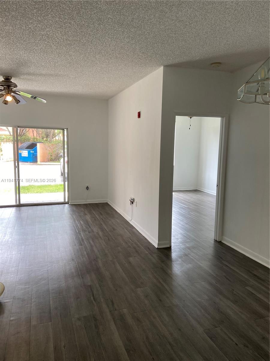 6960 Southwest 39th Street, Unit E107 Davie, FL 33314 - Photo 2 of 2 a view of an empty room with wooden floor