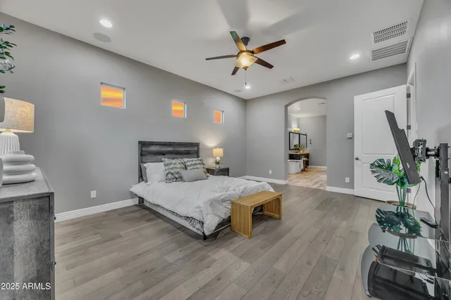 a bedroom with a bed and a chandelier