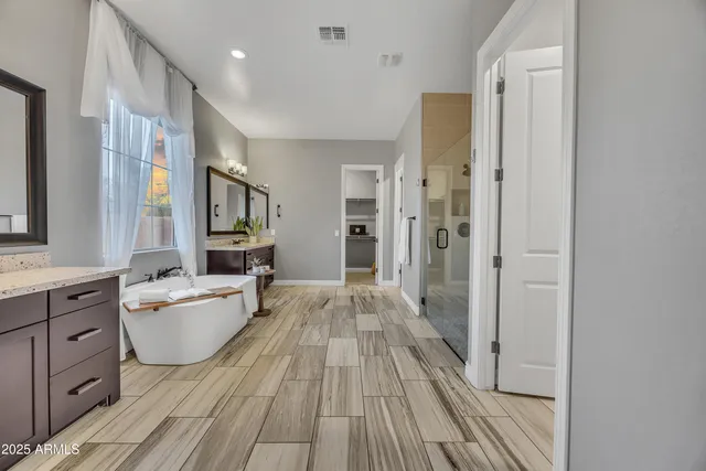 a large space with a large window and wooden floor