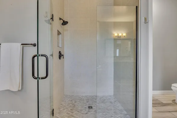 a bathroom with a glass shower door