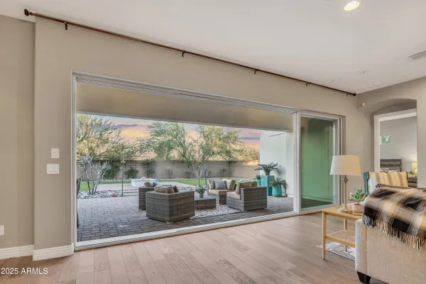 a living room with furniture and a floor to ceiling window
