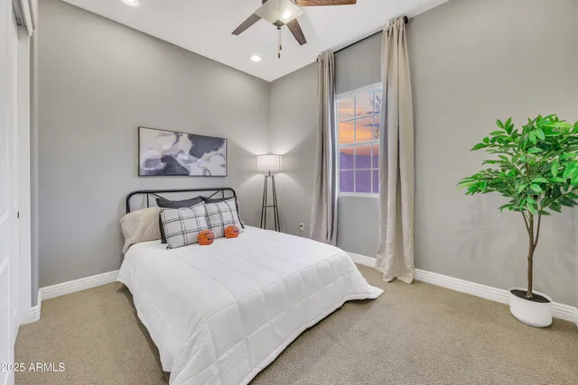 a bedroom with a bed and a potted plant