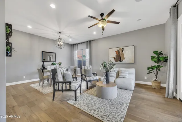 a living room with furniture and a chandelier