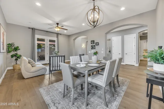 a view of a dining room with furniture wooden floor and chandelier