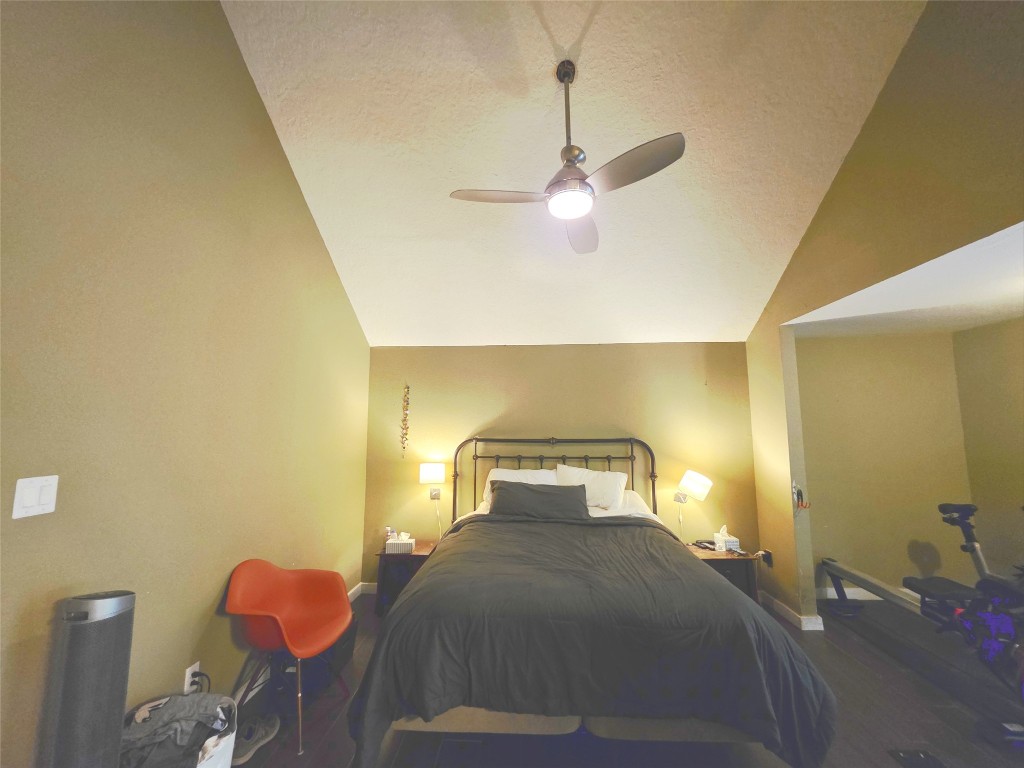 12410 Twin Creek Road Manchaca, TX 78652 - Photo 11 of 32 a bedroom with a bed and a chandelier