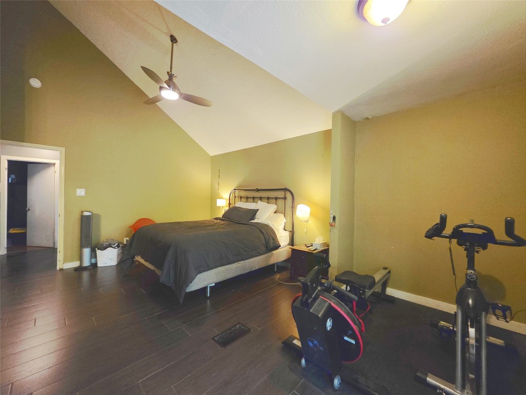 12410 Twin Creek Road Manchaca, TX 78652 - Photo 13 of 32 a bedroom with a bed and wooden floor