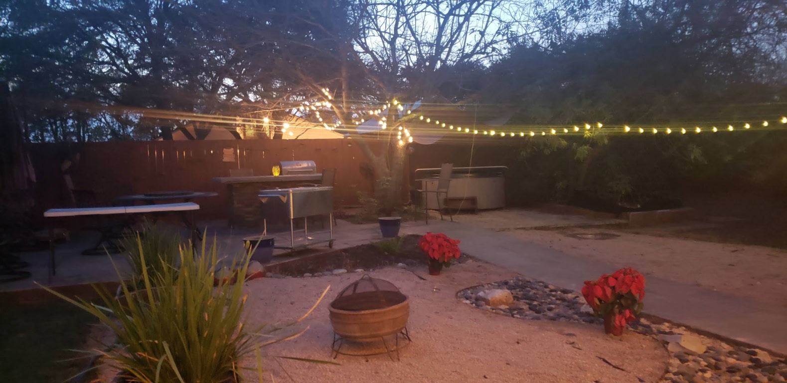 12410 Twin Creek Road Manchaca, TX 78652 - Photo 15 of 32 a view of a backyard with table and chairs potted plants