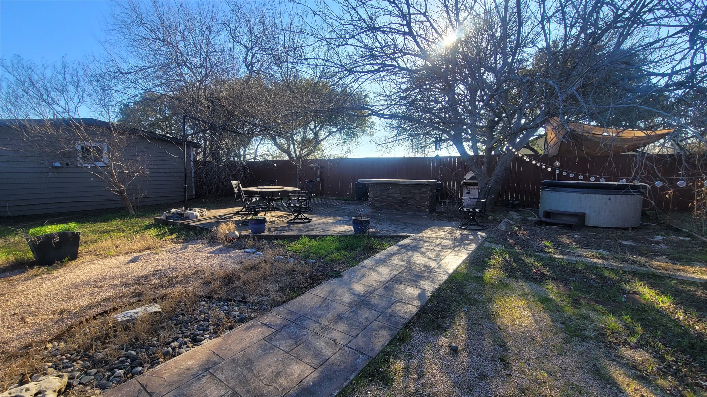 12410 Twin Creek Road Manchaca, TX 78652 - Photo 16 of 32 a view of a backyard with chair and tables
