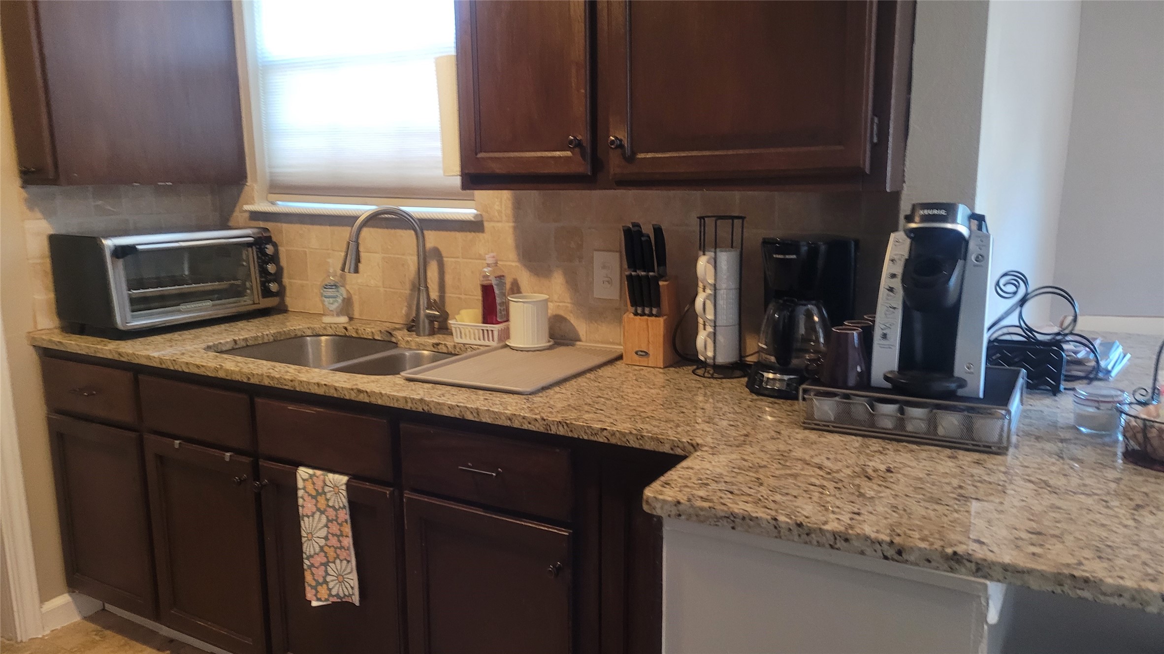 12410 Twin Creek Road Manchaca, TX 78652 - Photo 23 of 32 a kitchen with granite countertop a sink a stove and cabinets
