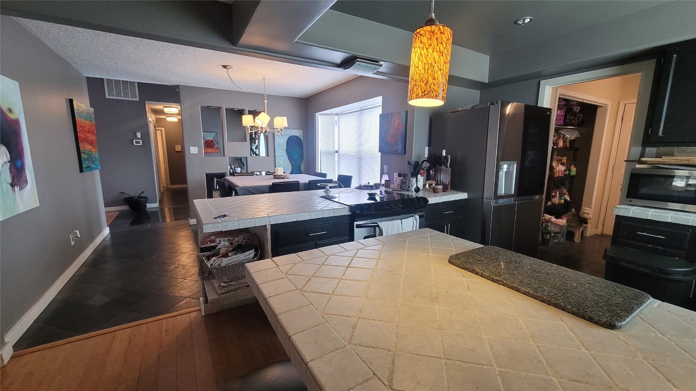 12410 Twin Creek Road Manchaca, TX 78652 - Photo 7 of 32 a large white kitchen with a large window