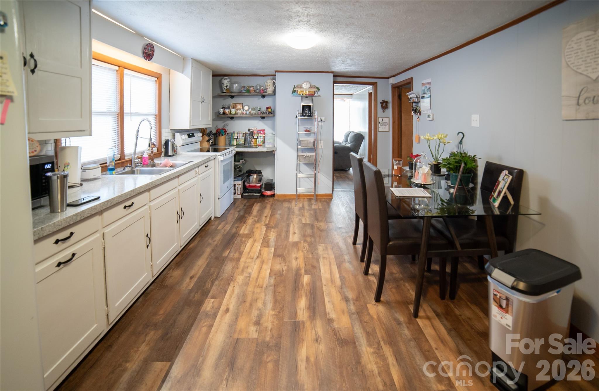 203 Cohen Street Morganton, NC 28655 - Photo 11 of 18 a kitchen with a table chairs and a wooden floor