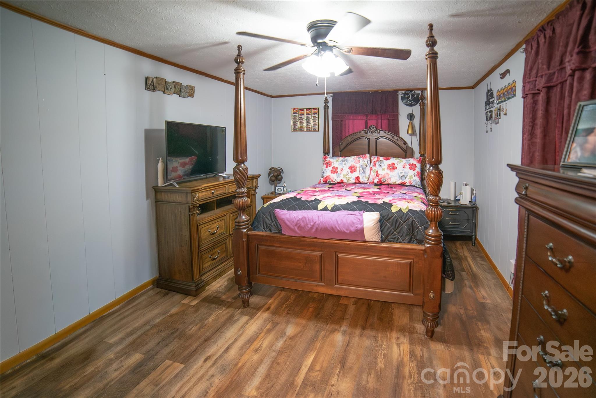 203 Cohen Street Morganton, NC 28655 - Photo 7 of 18 a bedroom with a bed and a flat tv screen on the dresser
