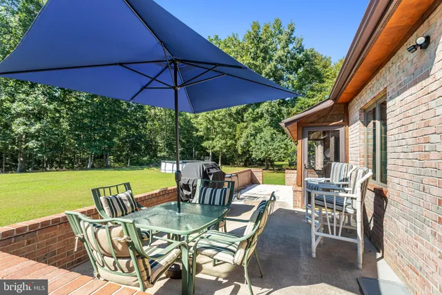 a view of an outdoor sitting area with furniture and backyard