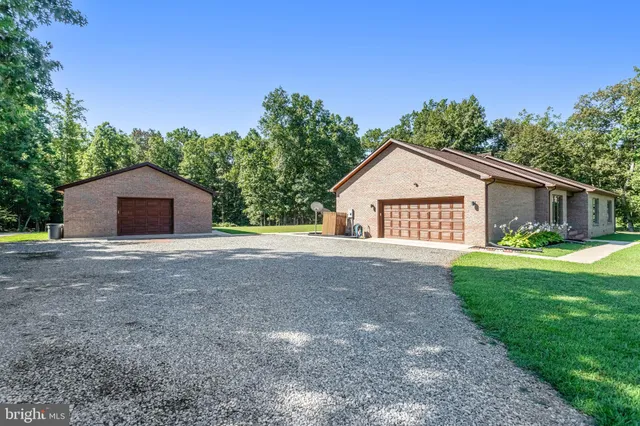 a view of front of a house with a yard and garage