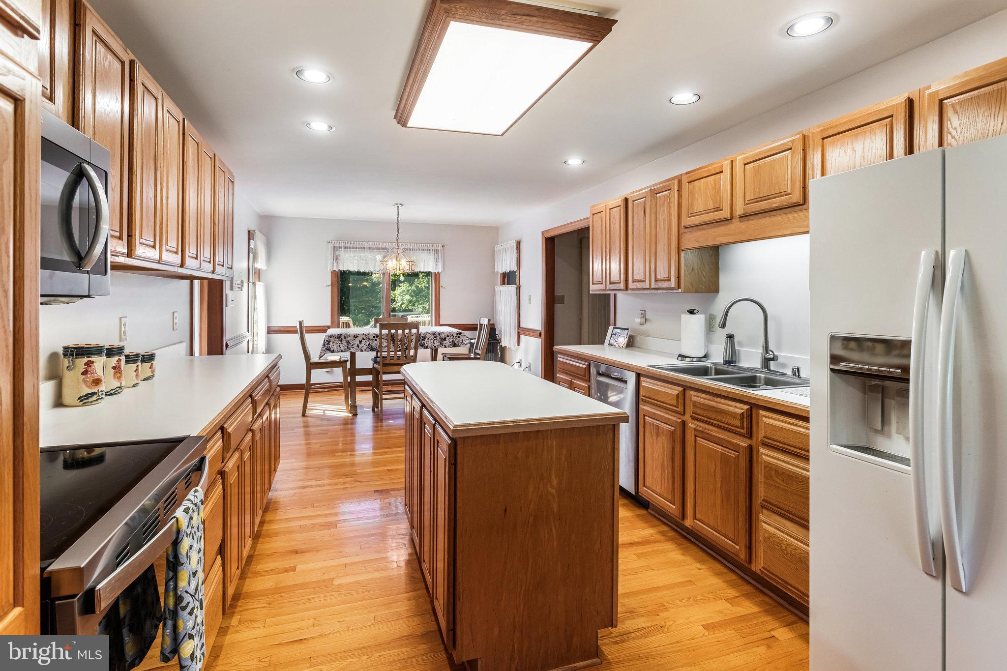 5119 Dickerson Road Partlow, VA 22534 - Photo 2 of 18 a kitchen with stainless steel appliances granite countertop lots of counter top space and wooden floor