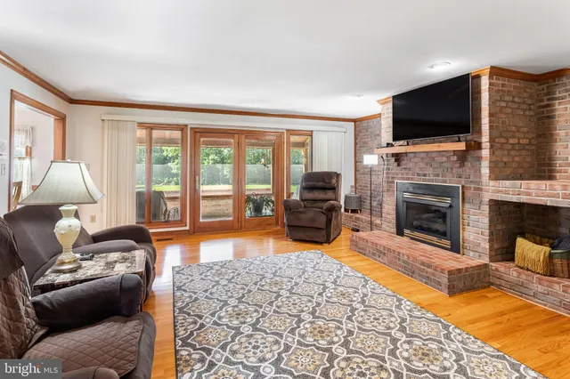 a living room with furniture fireplace and flat screen tv