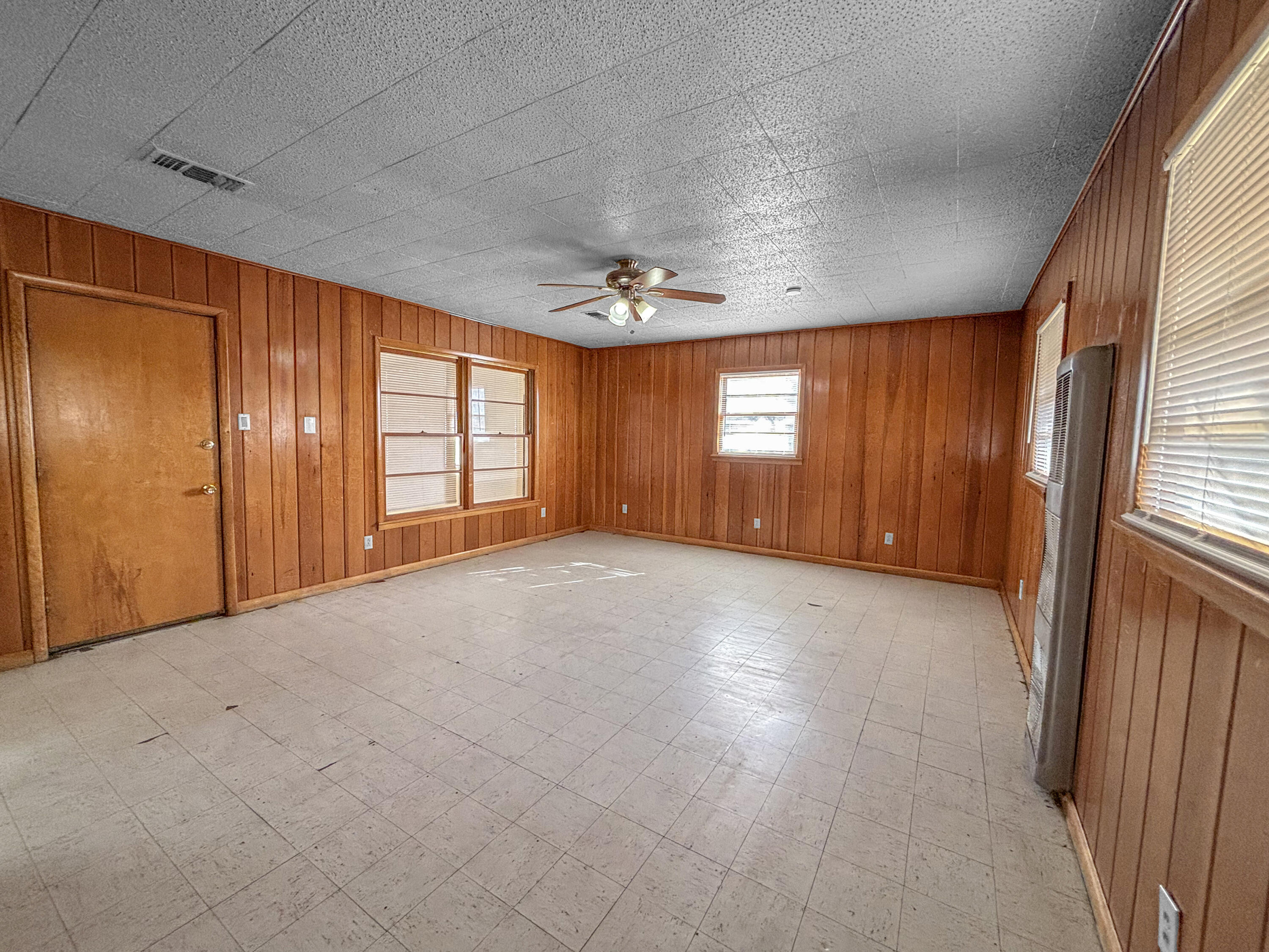 4411 45th Street Lubbock, TX 79414 - Photo 18 of 44 an empty room with windows and chandelier fan