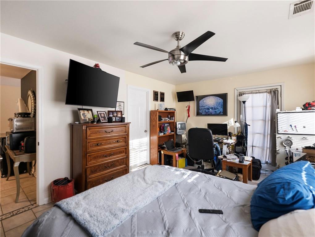 7389 Williams Road Flowery Branch, GA 30542 - Photo 29 of 49 a bedroom with furniture and a flat screen tv