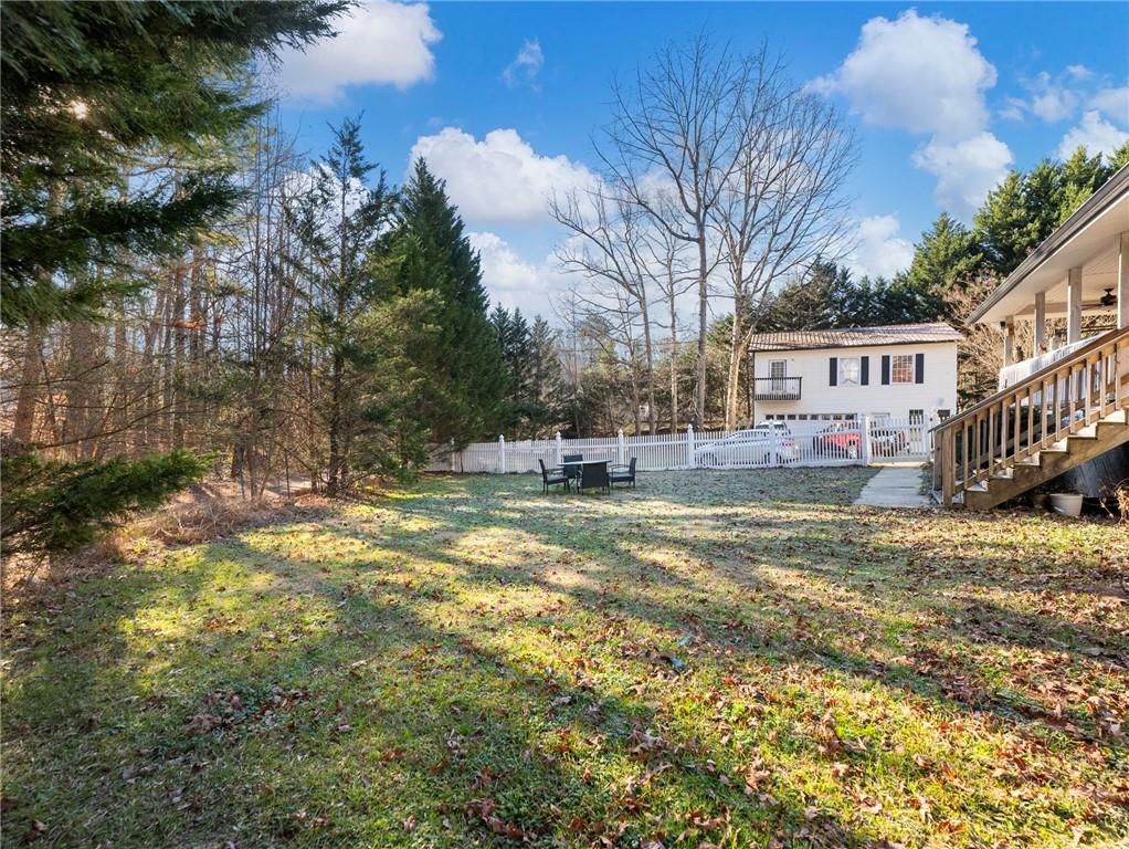 7389 Williams Road Flowery Branch, GA 30542 - Photo 45 of 49 a backyard of a house with table and chairs