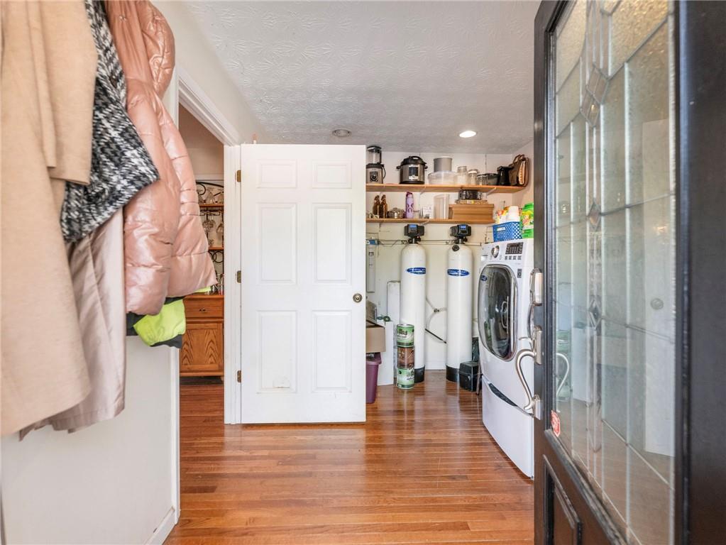 7389 Williams Road Flowery Branch, GA 30542 - Photo 7 of 49 a view of a hallway with wooden floor and a living room