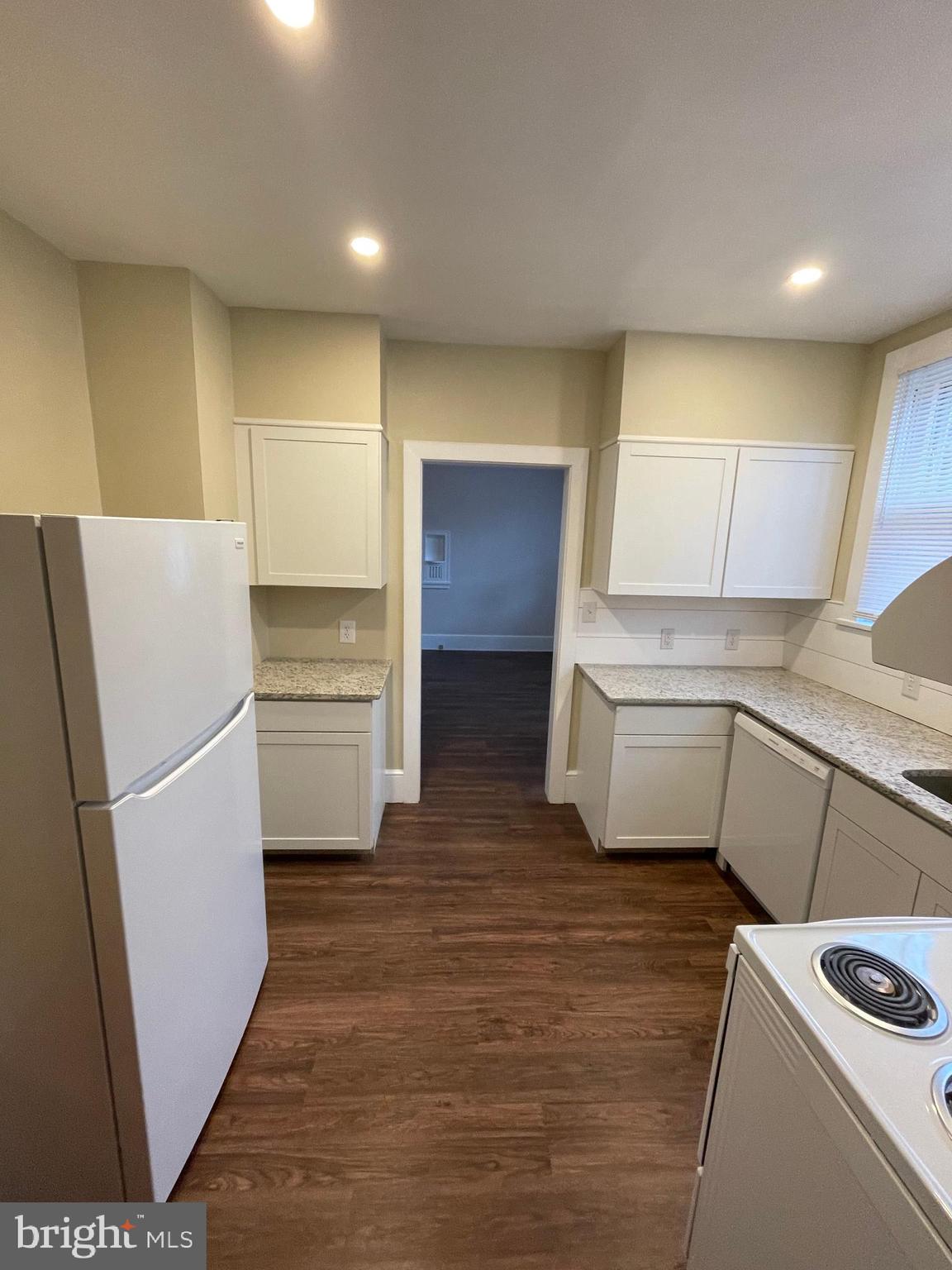 142 Riddle Road Chambersburg, PA 17201 - Photo 12 of 51 a kitchen with a refrigerator a stove top oven and cabinets