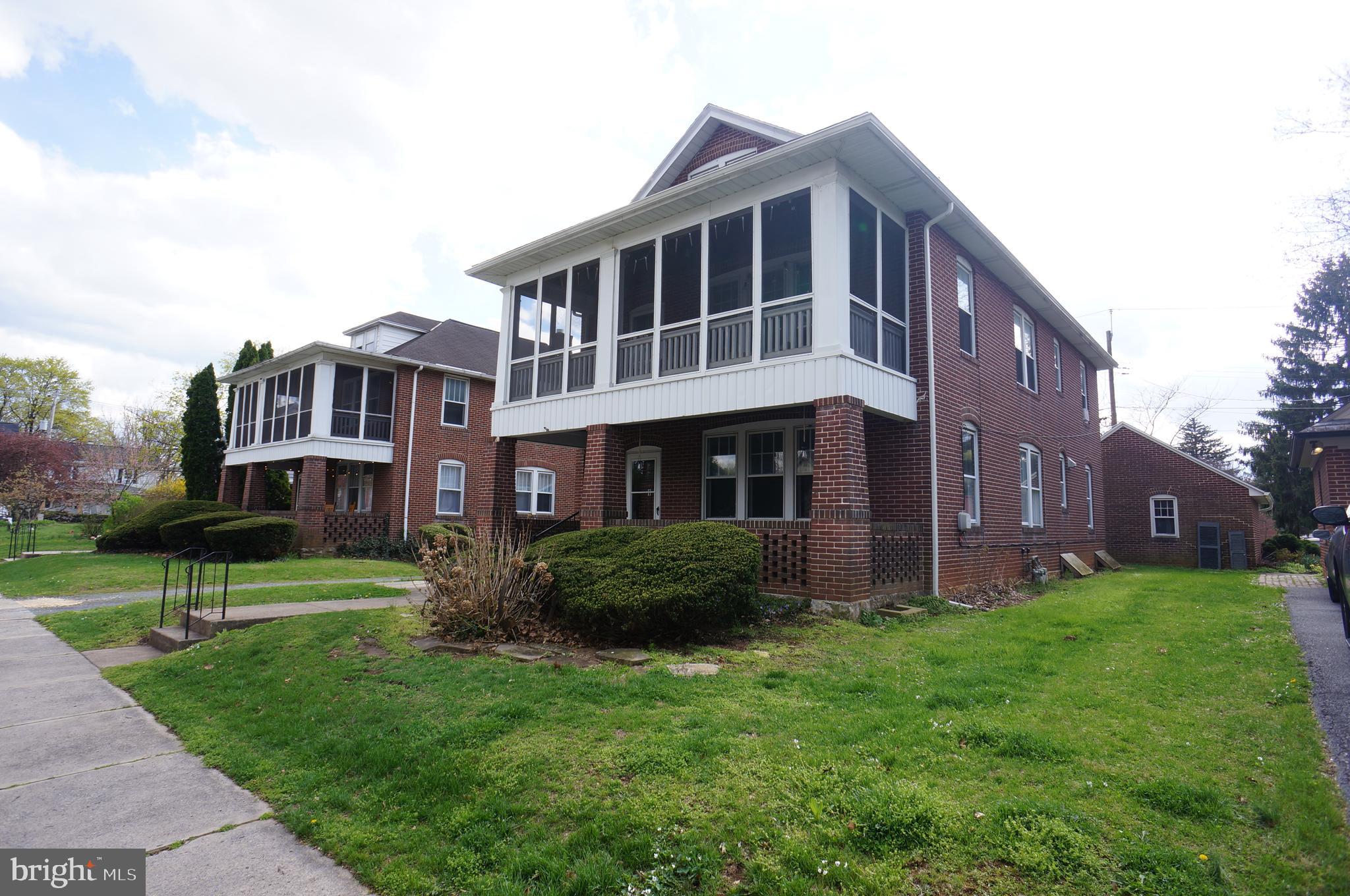 142 Riddle Road Chambersburg, PA 17201 - Photo 2 of 51 a large brick building with a yard in front of it