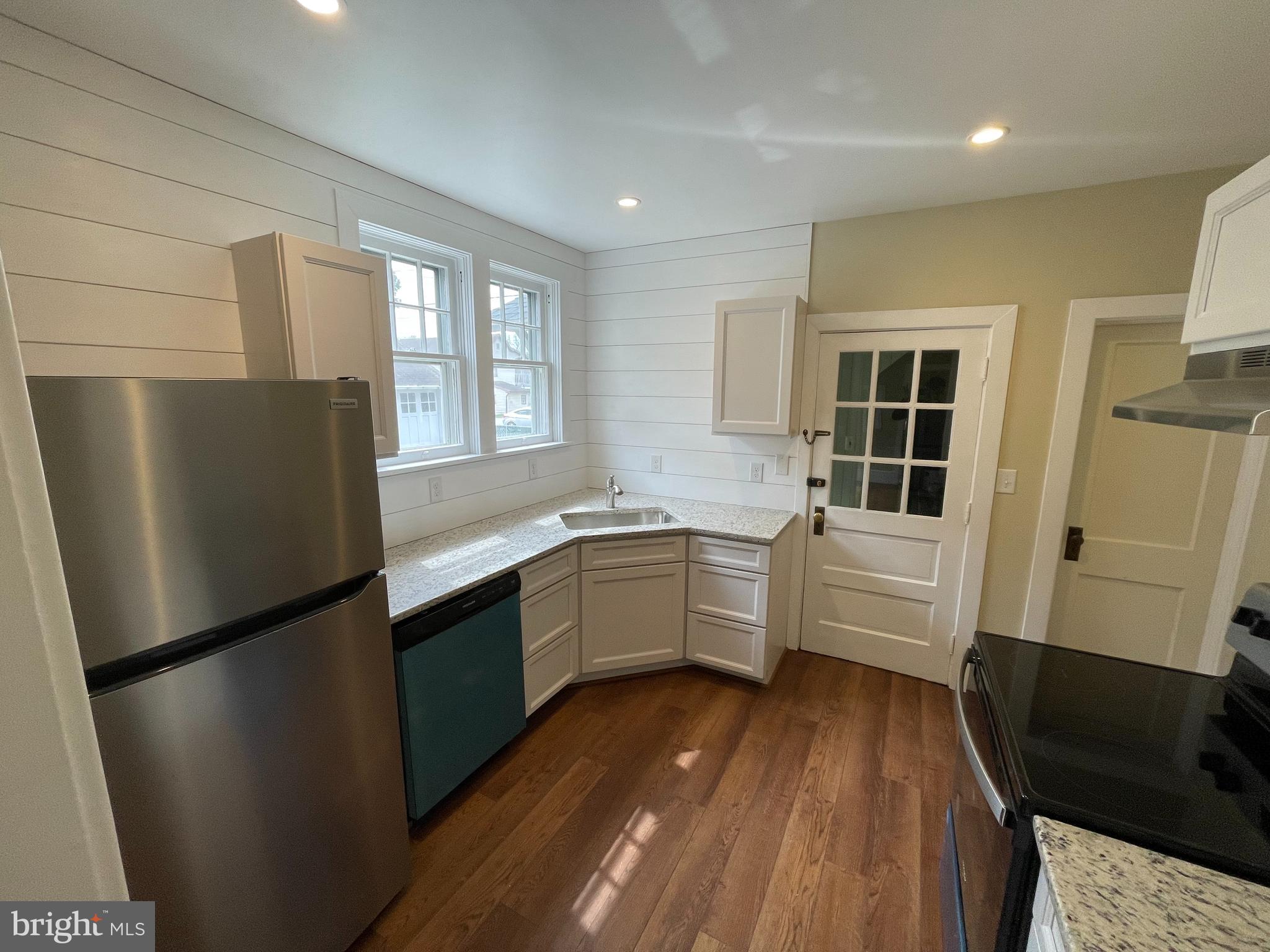 142 Riddle Road Chambersburg, PA 17201 - Photo 42 of 51 a kitchen with a refrigerator a sink and dishwasher with wooden floor